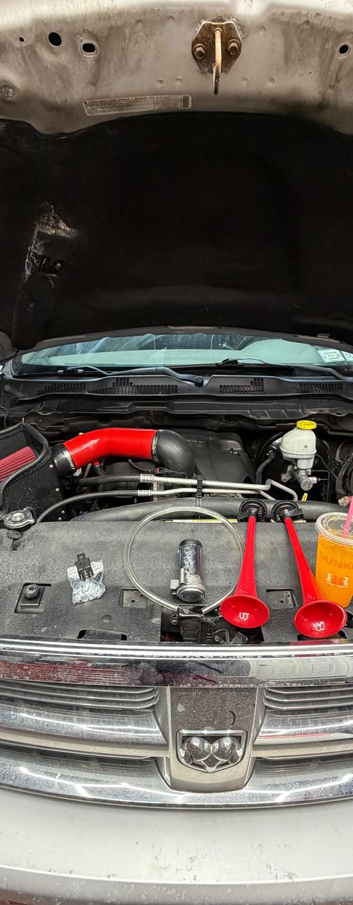 Engine bay with red-finished parts and the hood open